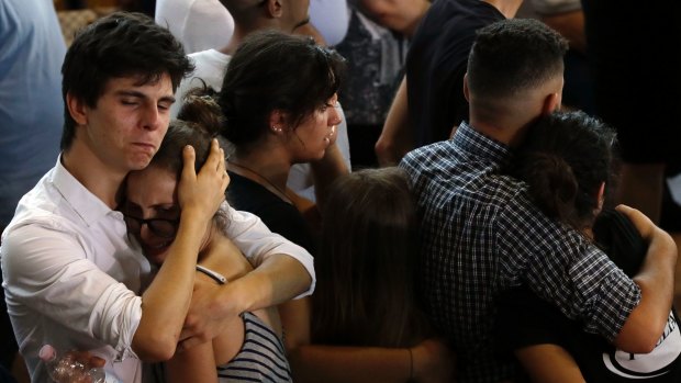 Relatives and friends mourn during the state funeral service of some of the earthquake victims in Ascoli Piceno, Italy.