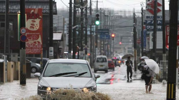 Coming down in buckets ... drivers battle through Sanjo City.