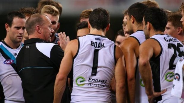 Ken Hinkley speaks to his players during a break in the game against the West Coast Eagles on Saturday.