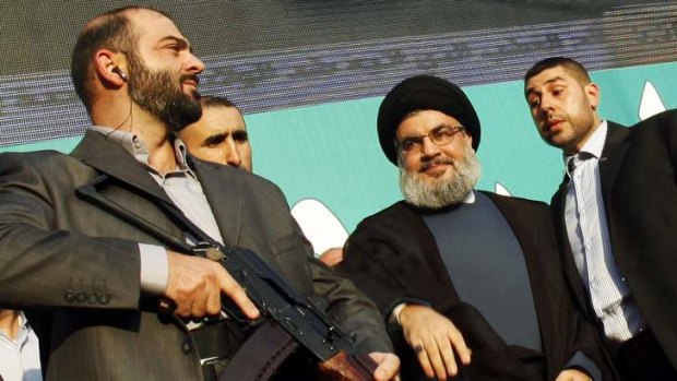 Lebanon's Hezbollah leader Sayyed Hassan Nasrallah (2nd R), escorted by his bodyguards, greets his supporters at an anti-US protest in Beirut's southern suburbs.