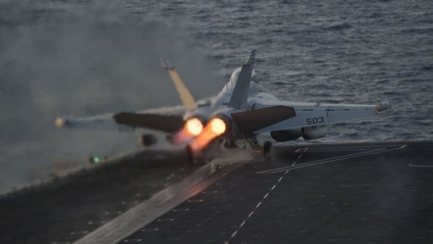 An EA-18G Growler takes off from USS Carl Vinson, the US aircraft carrier currently deployed in the Persian Gulf to support operations against Islamic State in Syria and Iraq.