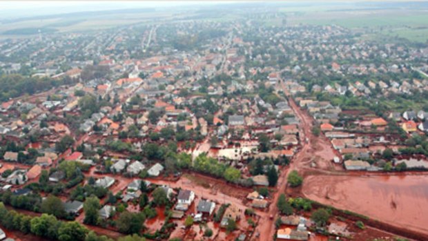 An aerial view of the red mud covering streets and neighborhood of Kolontar.