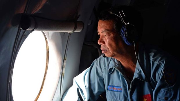 Massive aerial effort: A searcher on a Vietnamese Air Force plane on Sunday.