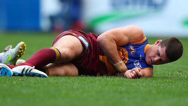 Injured Brisbane Lions skipper Jonathan Brown sprawls on the ground in the game against Geelong at the Gabba.