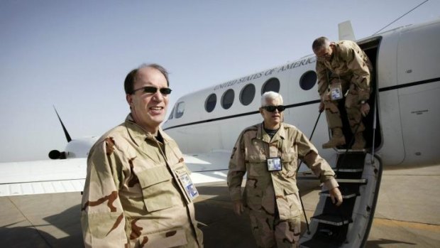 Money man: Stuart Bowen, left, and two aides get off a plane in the Iraqi city of Nasiriya in May 2006.