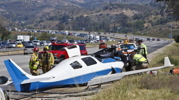 Emergency personnel investigate the scene of plane crash in Fallbrook, California.