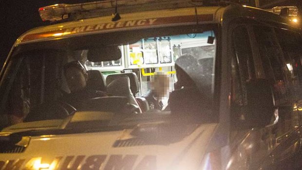 Ambulance officers tend to the injured policeman at Preston on Thursday night.