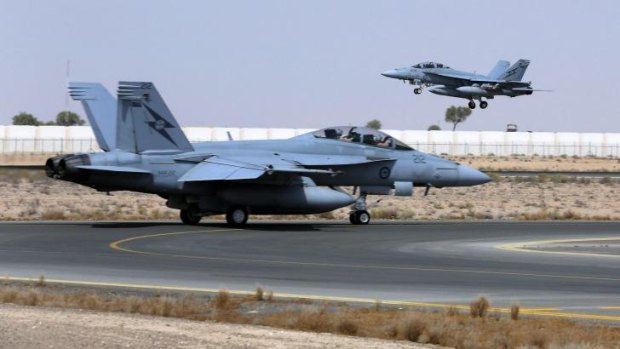 Air wars: A Royal Australian Air Force Super Hornet takes off as another aircraft taxis along the runway as they launch their first combat mission over Iraq.