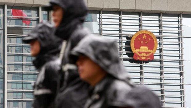 Public security personnel guard the Hefei Municiple Intermediary People's Court in Hefei, Anhui Province, China.