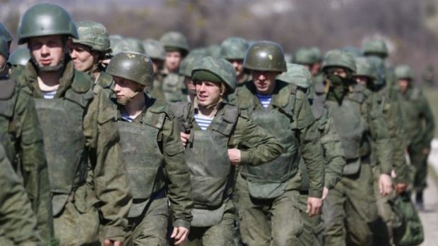 Uniformed men, believed to be Russian troops, march outside a military base in Perevalnoye, near the Crimean city of Simferopol.