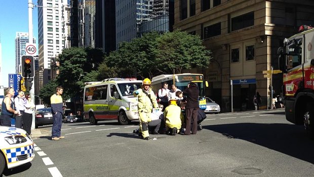 Emergency crews tend to a patient after an accident on the corner of Adelaide and Wharf streets.