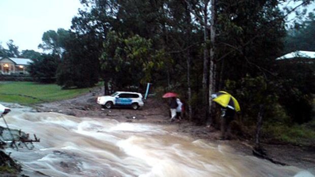 A water main has burst at Mt Crosby Road flooding a number of properties. Photo: ABC Radio612 (Also front page). 