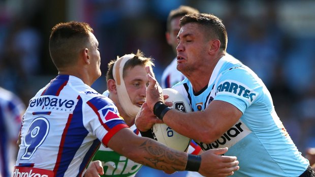 Point of impact: Chris Heighington of the Sharks is tackled at Southern Cross Group Stadium, where Mata'utia suffered two head knocks during the Knights' narrow loss.