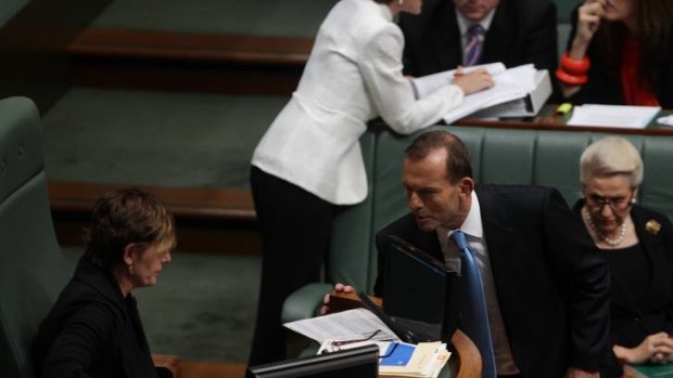 Opposition Leader Tony Abbott speaks with Deputy Speaker Anna Burke during Question Time