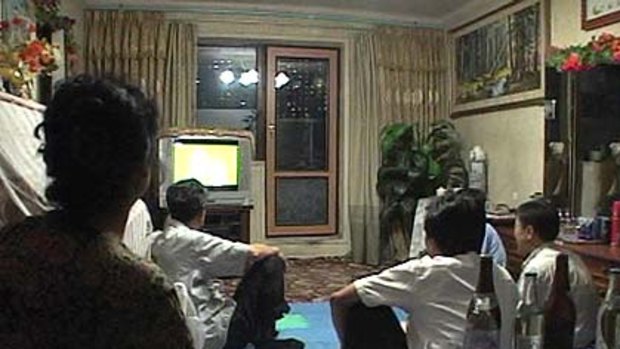 North Koreans watch the World Cup group G soccer match between Portugal and North Korea on television at an apartment in Pyongyang.