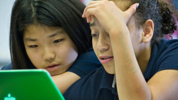 Nina Jenkins, right, and Susie Yoon, sixth-graders at Flint Hill School, work on their school-issued laptops.