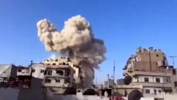 Fighting intensifies ... an image taken from video footage shows the aftermath of an air attack on Homs by government forces.