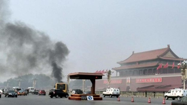 Smoke rises into the air in Tiananmen Square after a four-wheel-drive burst into flames in what Chinese authorities say was an attack by Uighur Islamists.