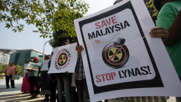 Activists hold placards during a demonstration against Lynas Corp's rare earth plant in Malaysia.