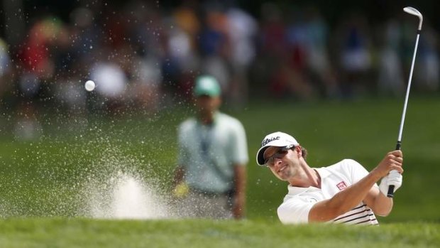 Adam Scott hits from a bunker to the fourth green during the first round of the PGA Championship.
