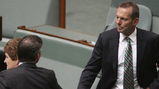 Tony Abbott greets independent MP Rob Oakeshott at the opening of Federal Parliament.