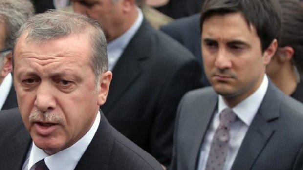 Yusuf Yerkel stands behind Prime Minister Recep Tayyip Erdogan.