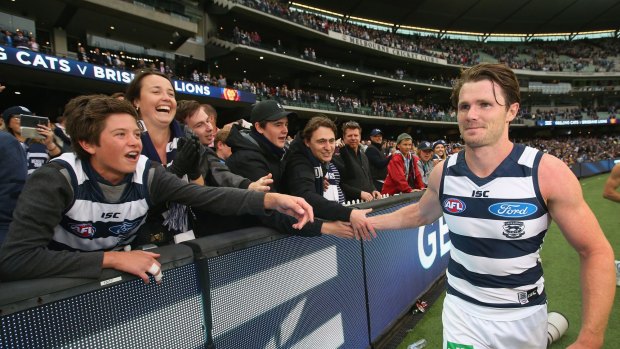 Emerging favourite: Patrick Dangerfield celebrates after the game with Cats fans.