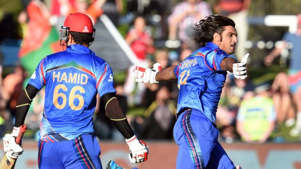 Afghanistan tailender Shapoor Zadran runs away in excitement after hitting the winning runs against Scotland.