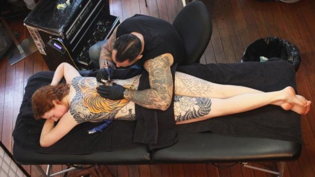 Going with the flow: Tattooist Kian "Horisumi" Forreal gives Elkie Lewer a full back, neck to knee image of a tiger.