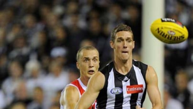 On the run: Collingwood's Shae McNamara leads Ted Richards to the ball.