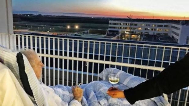 Carsten Flemming Hansen enjoys a final glass of wine and a cigarette while viewing the sunset. 
