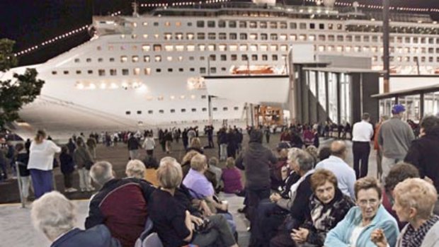 Passengers dwait to board the Dawn Princess Cruise Ship.