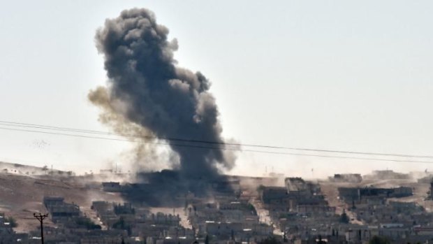 Desperate battle ... smoke rises from the Syrian town of Kobane as Kurdish forces defend it from Islamic State militants.