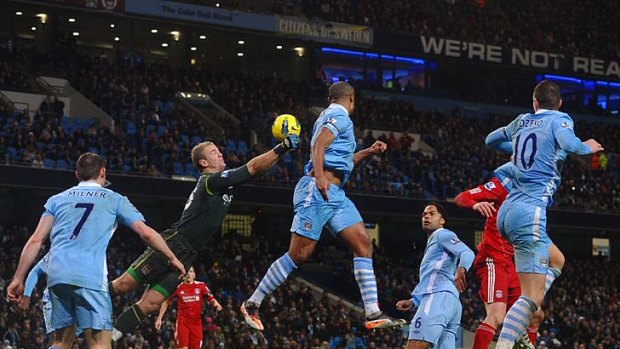 Manchester City's English goalkeeper Joe Hart (second left) makes a save against Liverpool.