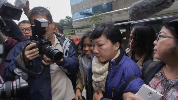 High-profile case ... former Indonesian domestic helper Erwiana Sulistyaningsih is swamped by media as she  arrives at a Hong Kong court.