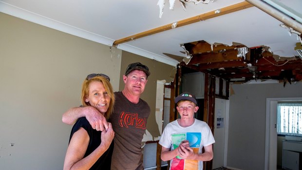 Tracey and Gavin Sant with oldest child Drew, 14, inside their damaged home at Kurnell.
