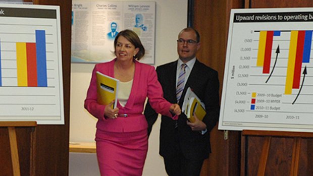 In the pink ... Premier Anna Bligh and Treasurer Andrew Fraser arrive to deliver the state budget today.