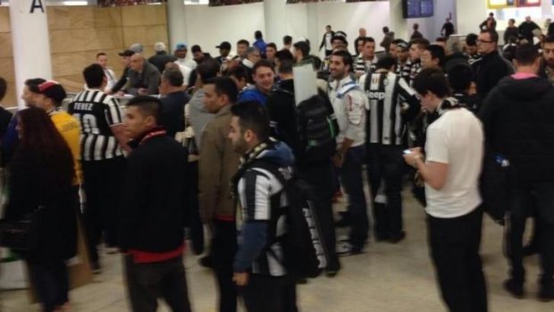 Juventus fans jostle for prime viewing position at Sydney airport.