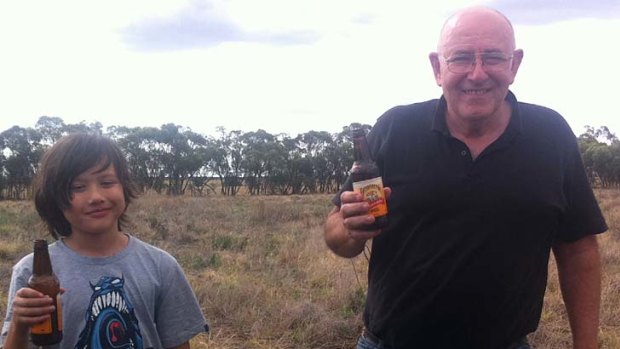 Jason and his father Robert celebrate retrieving their weather balloon, which captured data and images on a mission a quarter of the way to space.