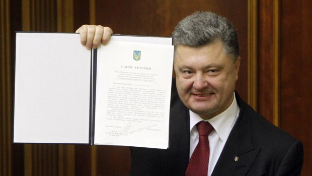 Landmark agreement: Ukraine's President Petro Poroshenko shows the association agreement with the European Union.
