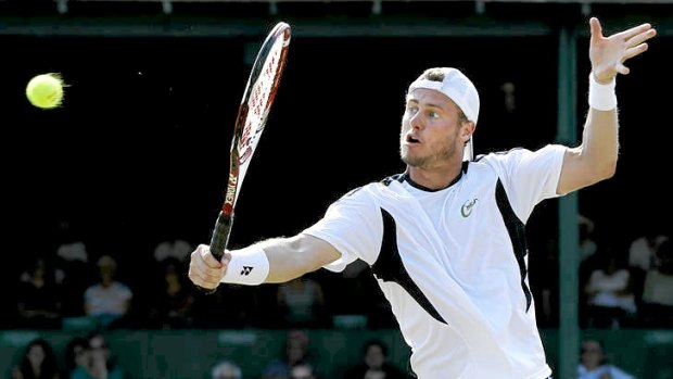 Lleyton Hewitt plays a backhand volley in a grasscourt tournament at Newport, Rhode Island in the lead-up to the Olympics. He lost in the final to American John Isner.