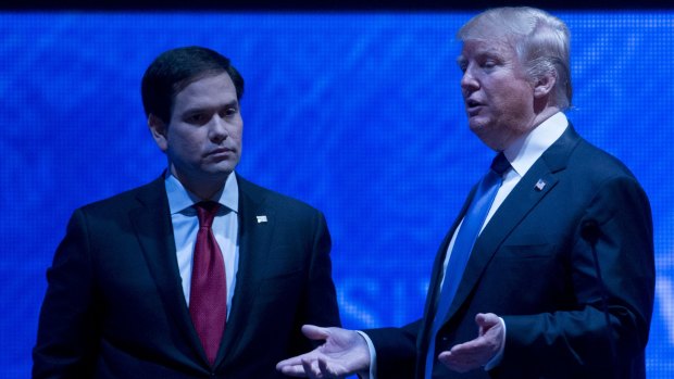 Donald Trump and Marco Rubio (left) speak during a break in the debate.
