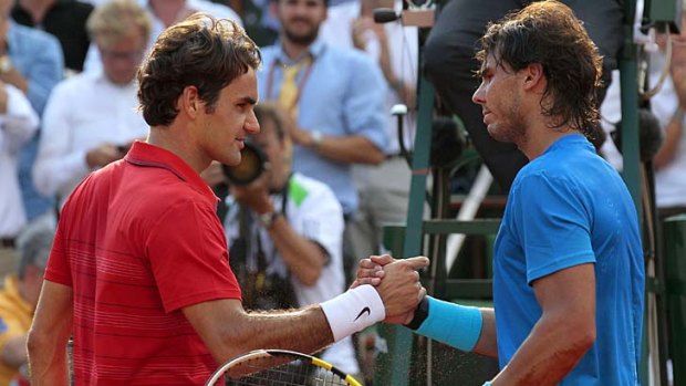 Reigning man from Spain: Roger Federer congratulates Rafael Nadal after Nadal's win in the French Open final earlier this month.
