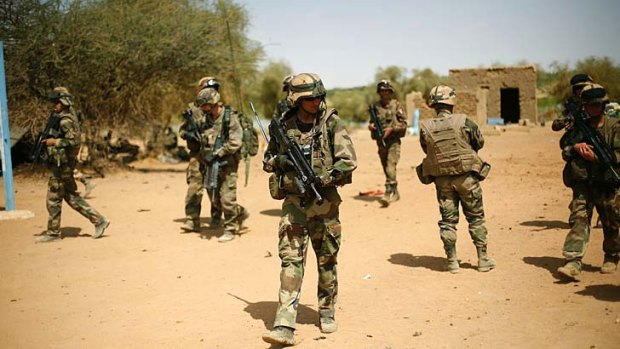 On alert ... French soldiers secure the area where a suicide bomber attempted to attack in Gao.