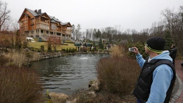 Nice digs ... A man takes pictures of the Mezhyhirya residence of Ukraine's President Viktor Yanukovich in the village Novi Petrivtsi.