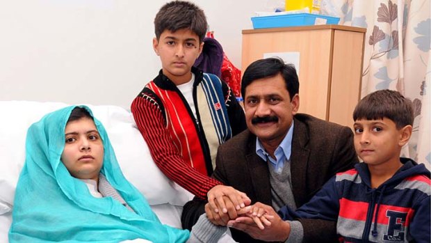 Malala Yousafzai with her father, Ziauddin, and brothers, Khushal Khan and Apal Khan.