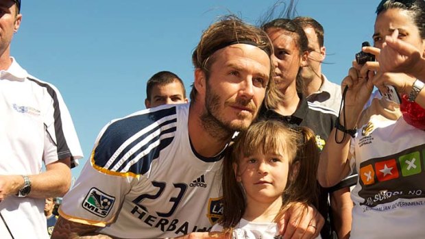 Eight-year-old indigenous soccer star Kyleisha Kinces meets 36-year-old soccer superstar David Beckham in Melbourne yesterday.