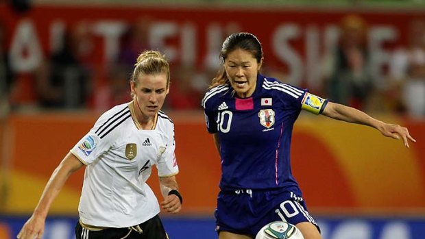 Simone Laudehr of Germany and Homare Sawa of Japan in a tussle for possession.