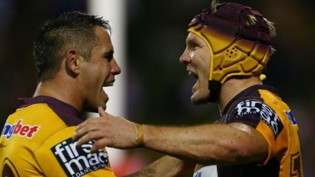 Buzzing Broncos: Todd Lowrie celebrates with Corey Parker (left) after scoring against the Dragons on Friday night.