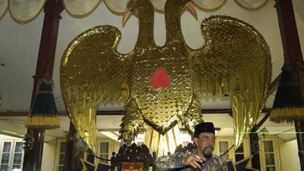 The Sultan of Ternate Kingdom, Mudaffar Syah, sits down in front of the kingdom's symbol in his palace in North Maluku, Indonesia. <i>Photo: Mosista Pambudi</i>